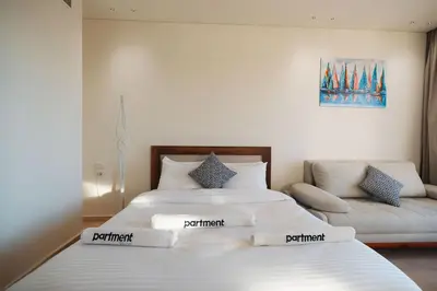 a bedroom with two beds and a couch at Tranquil Terrace Studio at Ancient Sands in Hurghada