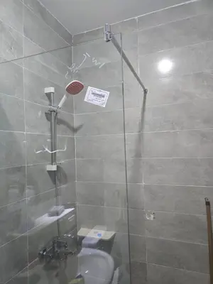a bathroom with a glass shower with a sink at tiba golden resort in Hurghada
