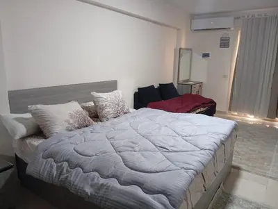 a bedroom with a large bed in a room at tiba golden resort in Hurghada
