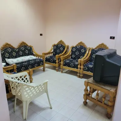 a room with a row of chairs and a tv at OS & MA Luxor APT in Luxor