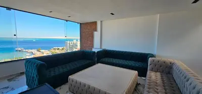 a room with two couches and a view of the ocean at Sea view Penthouse sea front city center 11 in Hurghada
