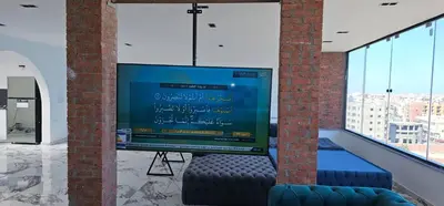 a large tv in a room with a window at Sea view Penthouse sea front city center 11 in Hurghada