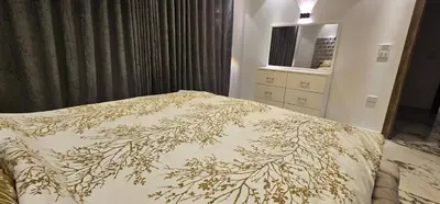 a bedroom with a bed with a floral bedspread at Sea view Penthouse sea front city center 11 in Hurghada
