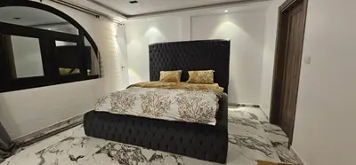 a bedroom with a bed with a black head board at Sea view Penthouse sea front city center 11 in Hurghada