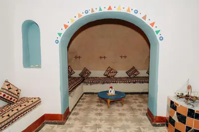 a living room with a table and a couch at Harmonia House in Al Karnak