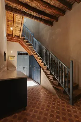 a staircase in a room with blue cabinets at Beit Felfel in Esna