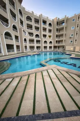 a large swimming pool in a building at Luxury Sea View Apt near Beach - 2 Pools - Balcony in Hurghada