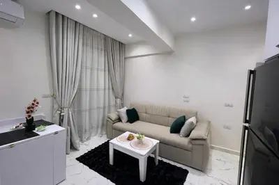 a living room with a couch and a table at Luxury Sea View Apt near Beach - 2 Pools - Balcony in Hurghada