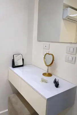 a white counter with a mirror and a sink at Luxury Sea View Apt near Beach - 2 Pools - Balcony in Hurghada