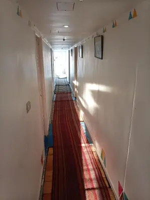 a long hallway with a red carpet on the floor at Nile Dream Yacht in Jazīrat Salūjah