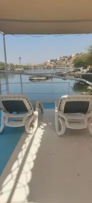 a pair of glasses sitting on the deck of a boat at Nile Dream Yacht in Jazīrat Salūjah
