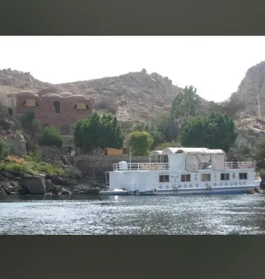 a large white boat on the water with a house at Nile Dream Yacht in Jazīrat Salūjah