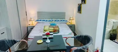 a small bedroom with a bed and a table and chairs at Gamal in Hurghada