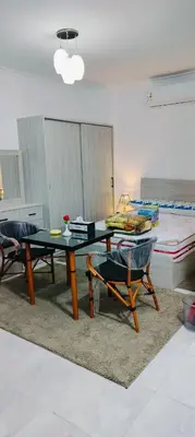 a living room with a table and two chairs at Gamal in Hurghada