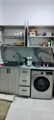 a kitchen with a sink and a washing machine at Gamal in Hurghada