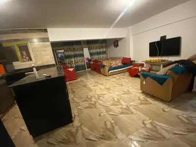 a living room with two couches and a television at 2-Room Apartment with Swimming Pool in Hurghada