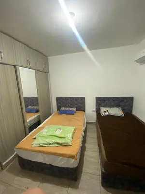 a room with two beds and a light on the ceiling at 2-Room Apartment with Swimming Pool in Hurghada