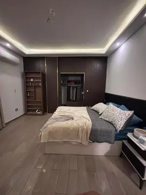 a bedroom with a large bed and a wooden floor at Unique apartment in hurghada in Hurghada