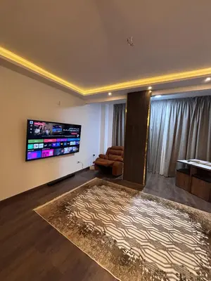 a living room with a flat screen tv and a couch at Unique apartment in hurghada in Hurghada