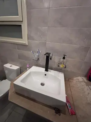 a white sink in a bathroom with a toilet at Unique apartment in hurghada in Hurghada