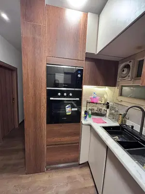 a small kitchen with a stove and a microwave at Unique apartment in hurghada in Hurghada