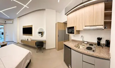 a kitchen with a sink and a bed in a room at Arabia FANTA SEA - Stylish Pool Level Studio in Florenza Hrg in Hurghada