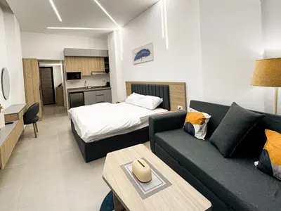 a living room with a couch and a bed at Arabia FANTA SEA - Stylish Pool Level Studio in Florenza Hrg in Hurghada