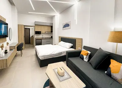 a living room with a couch and a bed at Arabia FANTA SEA - Stylish Pool Level Studio in Florenza Hrg in Hurghada