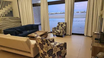a living room with a view of the ocean at Elgouna -4 bedroom villa with private heated pool in Hurghada