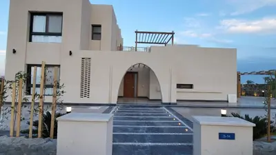a house with a staircase leading up to a building at Elgouna -4 bedroom villa with private heated pool in Hurghada
