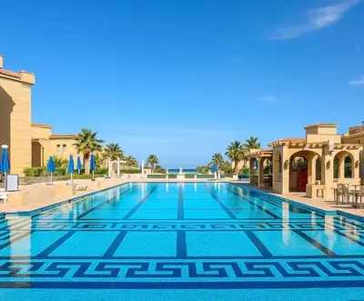 a swimming pool in a resort with palm trees at Amazing 1 bedroom & sofa bed at Selenabay Hurghada in Hurghada