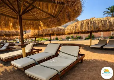 a group of lounge chairs and umbrellas on a beach at Tiba Golden in Hurghada