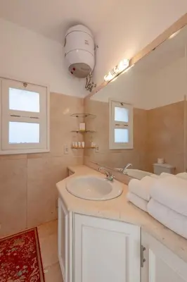 a bathroom with a sink and a mirror at VESTA - El Gouna Residence in Hurghada