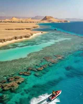 a person riding a boat in the water at VESTA - El Gouna Residence in Hurghada