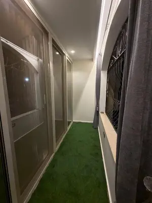 a hallway with green carpet and a room with windows at Hurghada - European standard apartment for rent! in Hurghada