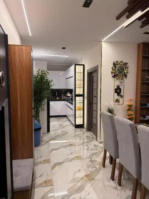 a living room with a table and chairs and a kitchen at Hurghada - European standard apartment for rent! in Hurghada