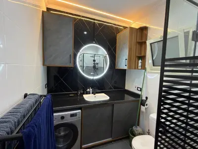 a bathroom with a sink and a washing machine at Hurghada - European standard apartment for rent! in Hurghada