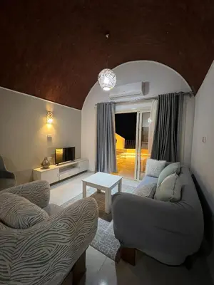 a living room with two couches and a table at Luxury Sea-View Rooftop with Private Terrace in Hurghada