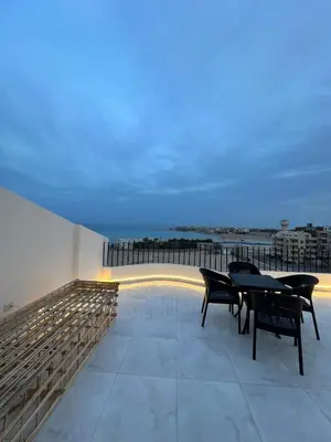 a balcony with a table and chairs on a building at Luxury Sea-View Rooftop with Private Terrace in Hurghada
