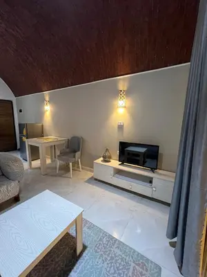 a living room with a tv and a couch and a table at Luxury Sea-View Rooftop with Private Terrace in Hurghada