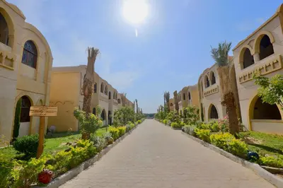 a cobblestone street in a courtyard with buildings at Saray El Omda - Egyptian Rural Village in Luxor