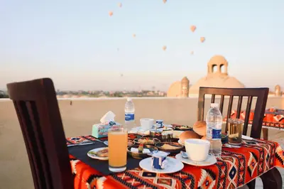 a table with food and drinks on top of the beach at Saray El Omda - Egyptian Rural Village in Luxor