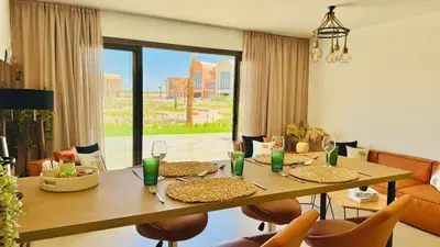 a dining room with a table with glasses and chairs at The Two Sisters - Kamaran, El Gouna in Hurghada