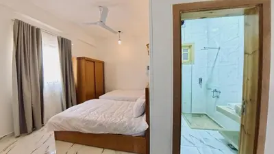 a bedroom with a bed and a glass shower at Luxor Hermes Guest House in Luxor