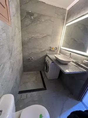 a bathroom with a sink and a toilet and a mirror at 3 bedroom duplex in Hurghada