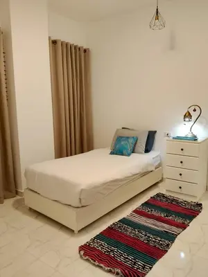 a bedroom with a bed and a dresser and a rug at The Arabic Jewel 2 Bedroom Home plus Sun Roof Terrace in Hurghada