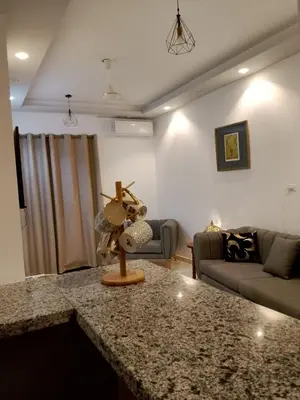 a kitchen with a counter top in a living room at The Arabic Jewel 2 Bedroom Home plus Sun Roof Terrace in Hurghada