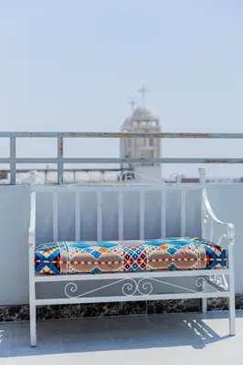a white bench sitting on top of a balcony at The Arabic Jewel 2 Bedroom Home plus Sun Roof Terrace in Hurghada