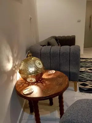 a living room with a table and a couch at The Arabic Jewel 2 Bedroom Home plus Sun Roof Terrace in Hurghada
