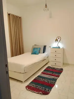 a bedroom with a bed and a dresser and a rug at The Arabic Jewel 2 Bedroom Home plus Sun Roof Terrace in Hurghada